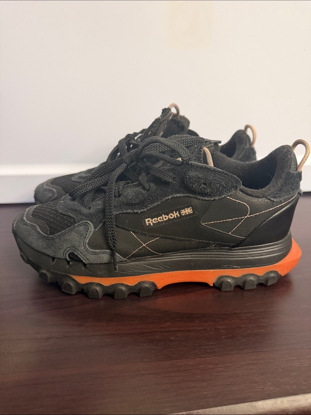 Cardi B Reebok Black Sneakers with Orange Midsole Accents
